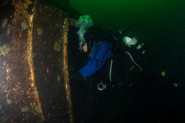 Diver exploring the Stanegarth - a wreck dive at Stoney Cove in Leicestershire, UK